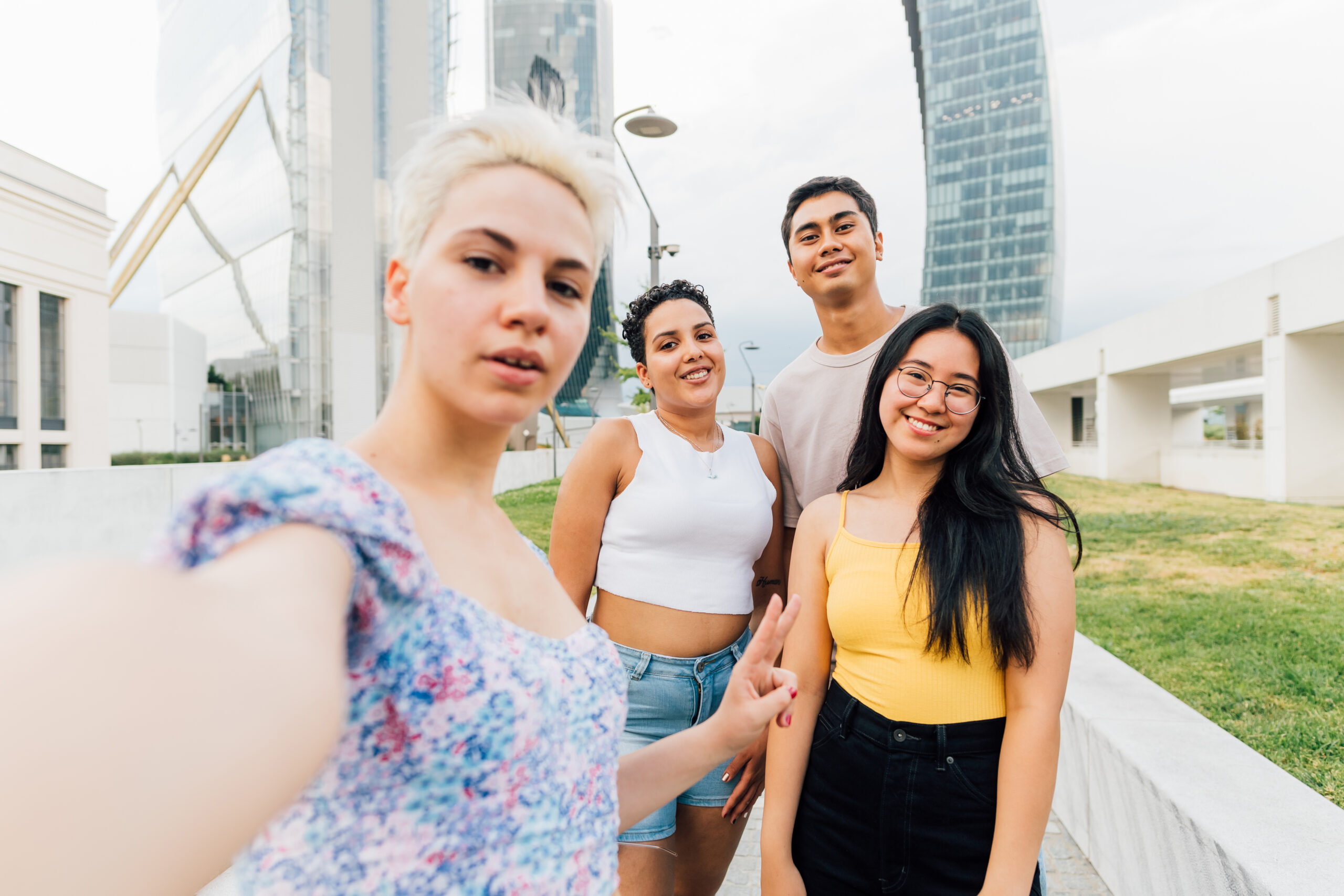 Group of multiethnic young friends outdoor taking selfie smiling